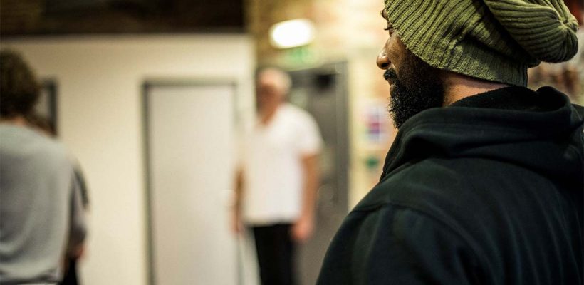 A photo of a man arriving at a homeless shelter.