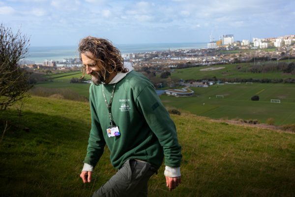 South Downs ranger Paul Gorringe walking on the hills of Sheepcote Valley